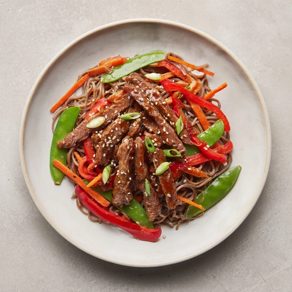 Steaming Teriyaki Beef & Noodle Bowl features glistening beef and vegetables coated in a rich, savory teriyaki sauce.