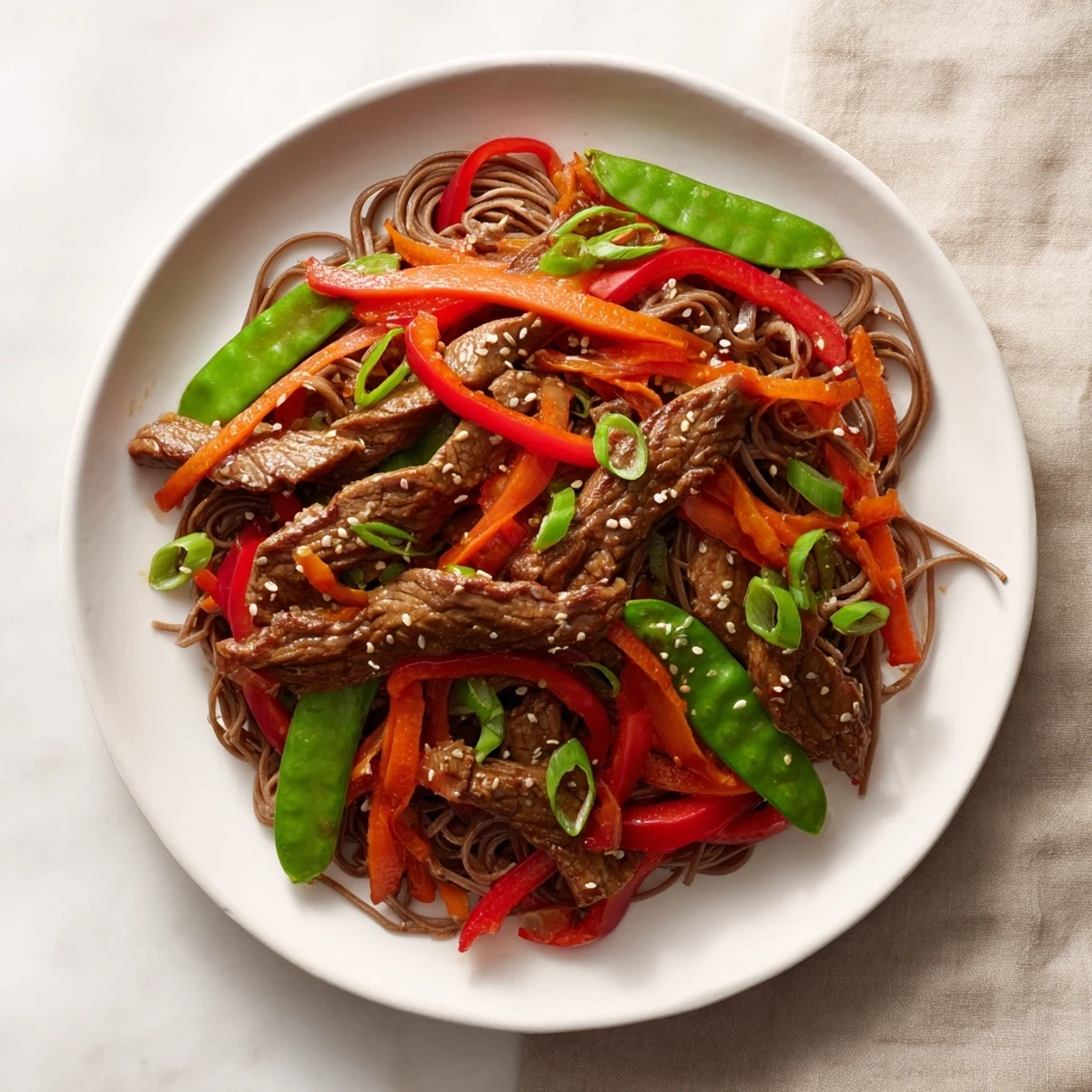 A close-up of a flavorful Teriyaki Beef & Noodle Bowl showcasing noodles, beef, and colorful vegetables, perfect for dinner.