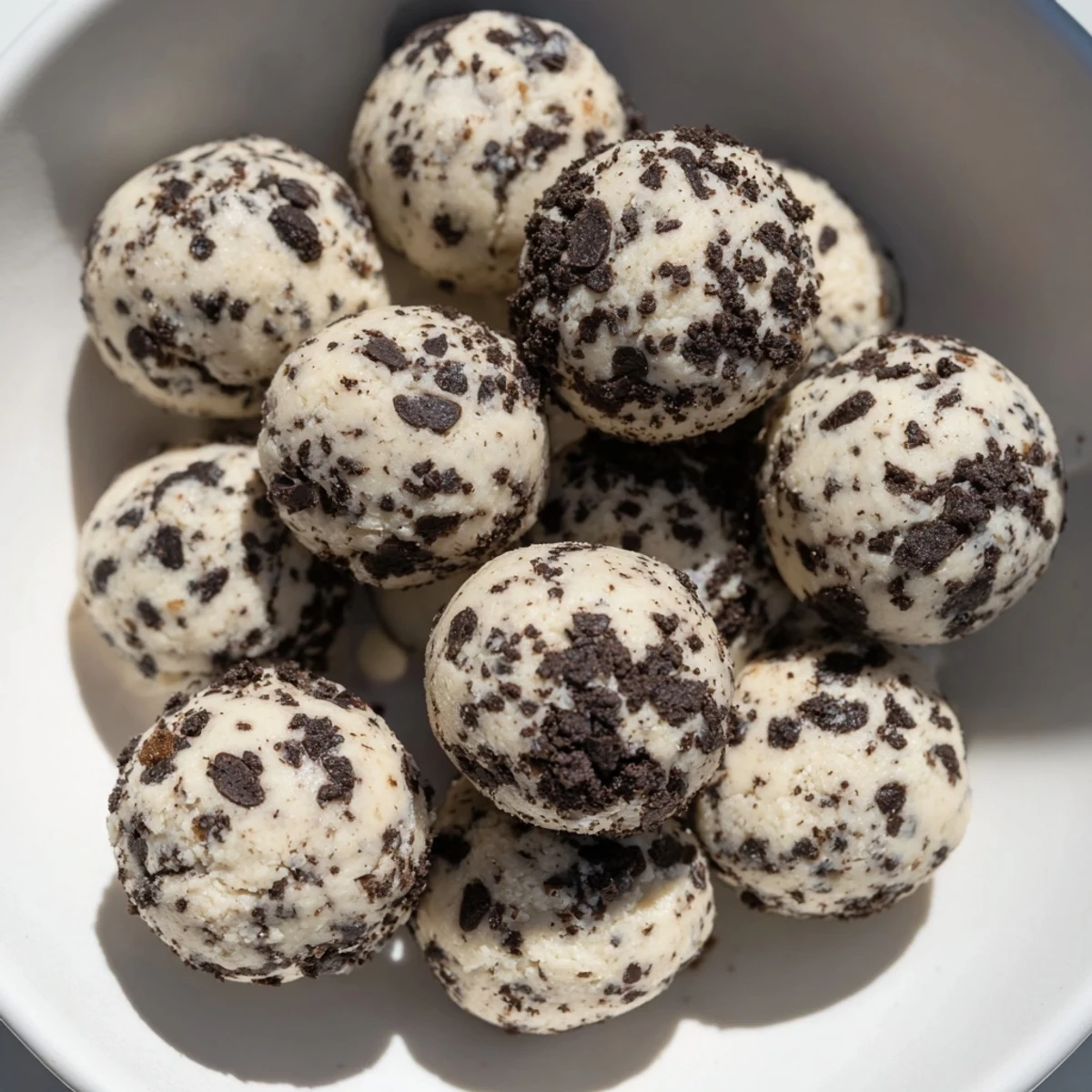 Cream Cheese Oreo Protein Balls ready to eat, showing a close-up of the creamy, crumb-covered treats.