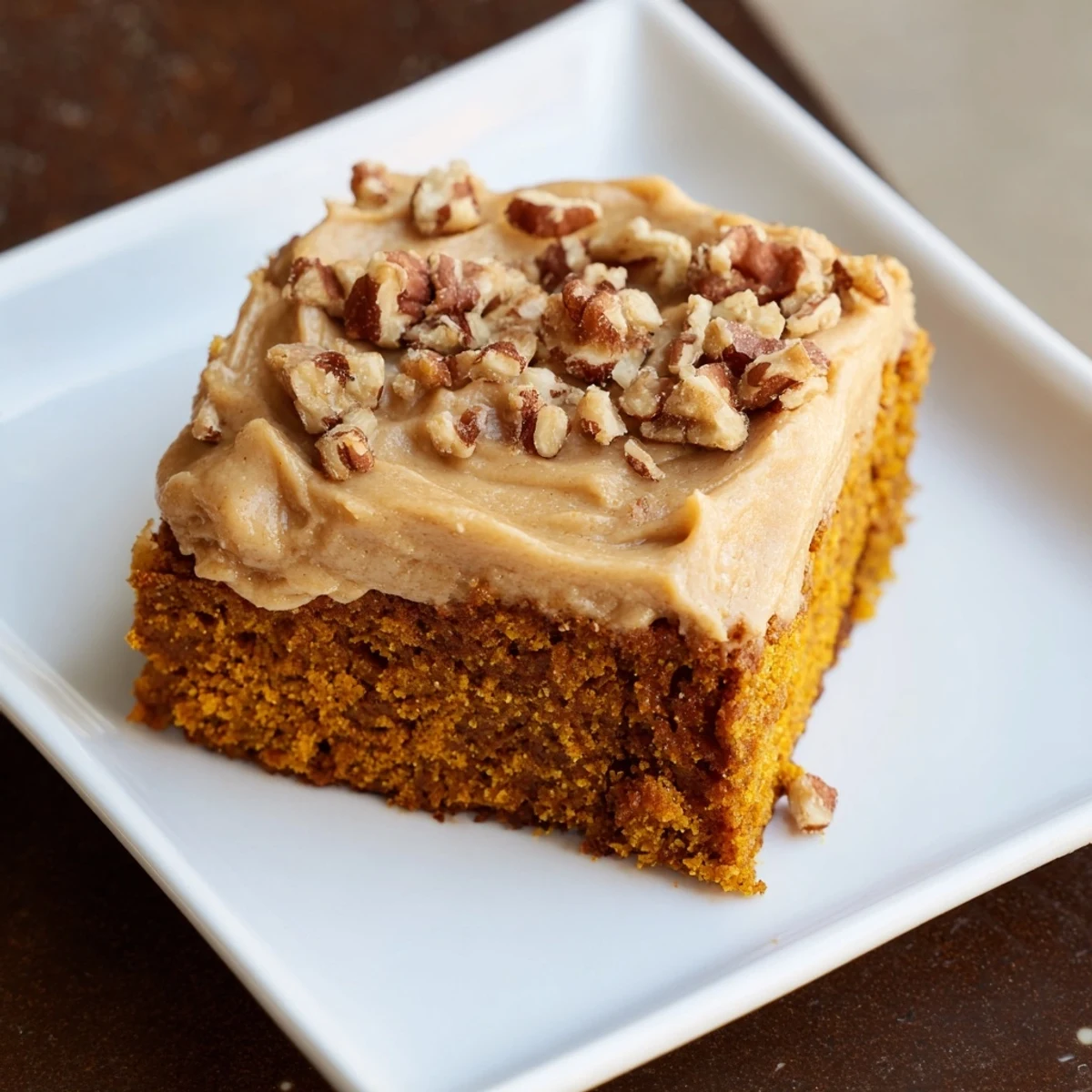 Warm pumpkin bars with rich brown sugar frosting, a decadent autumnal treat picture.