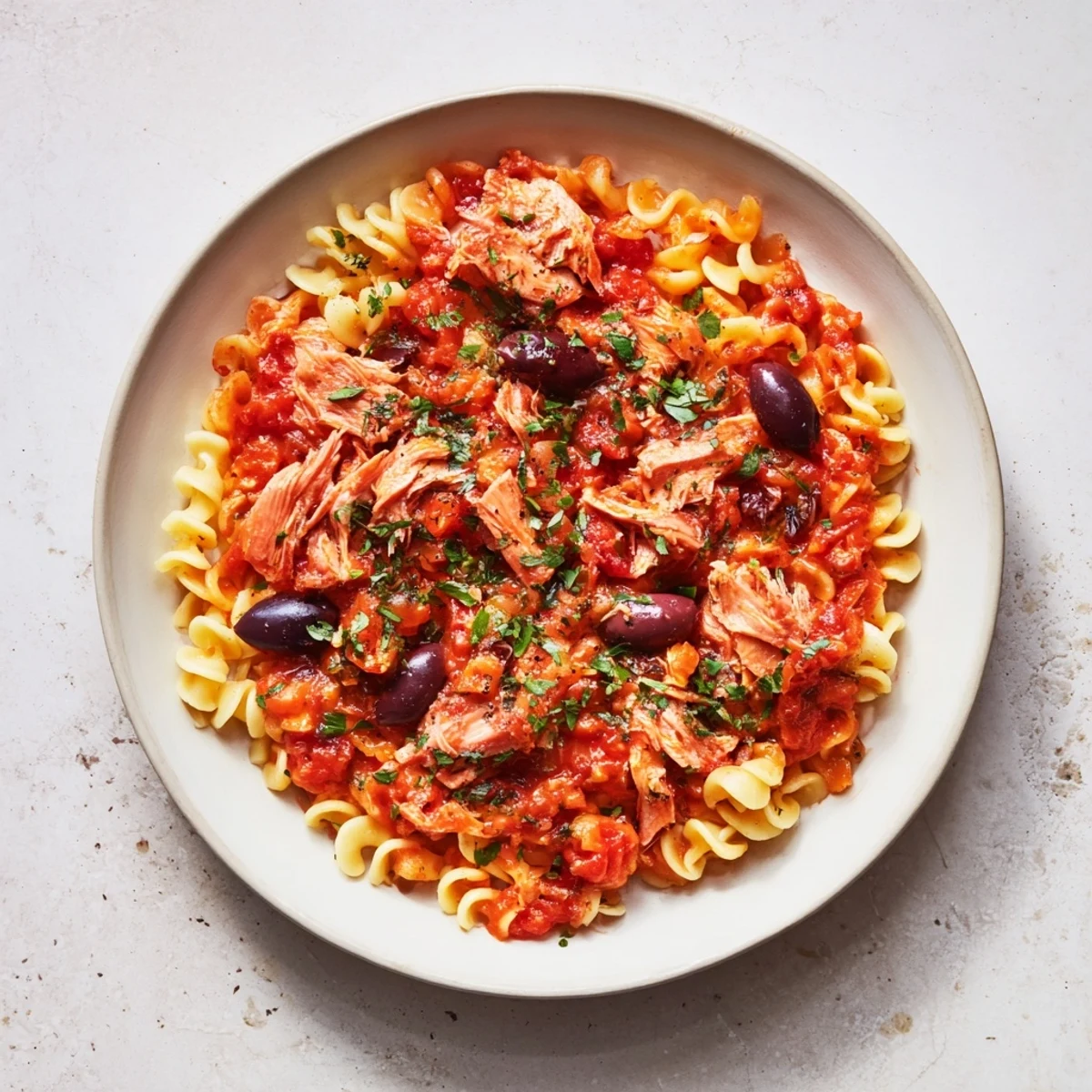 Steaming Puttanesca Ditalini, a flavorful Italian pasta dish with olives, capers, and tomatoes, ready to serve.