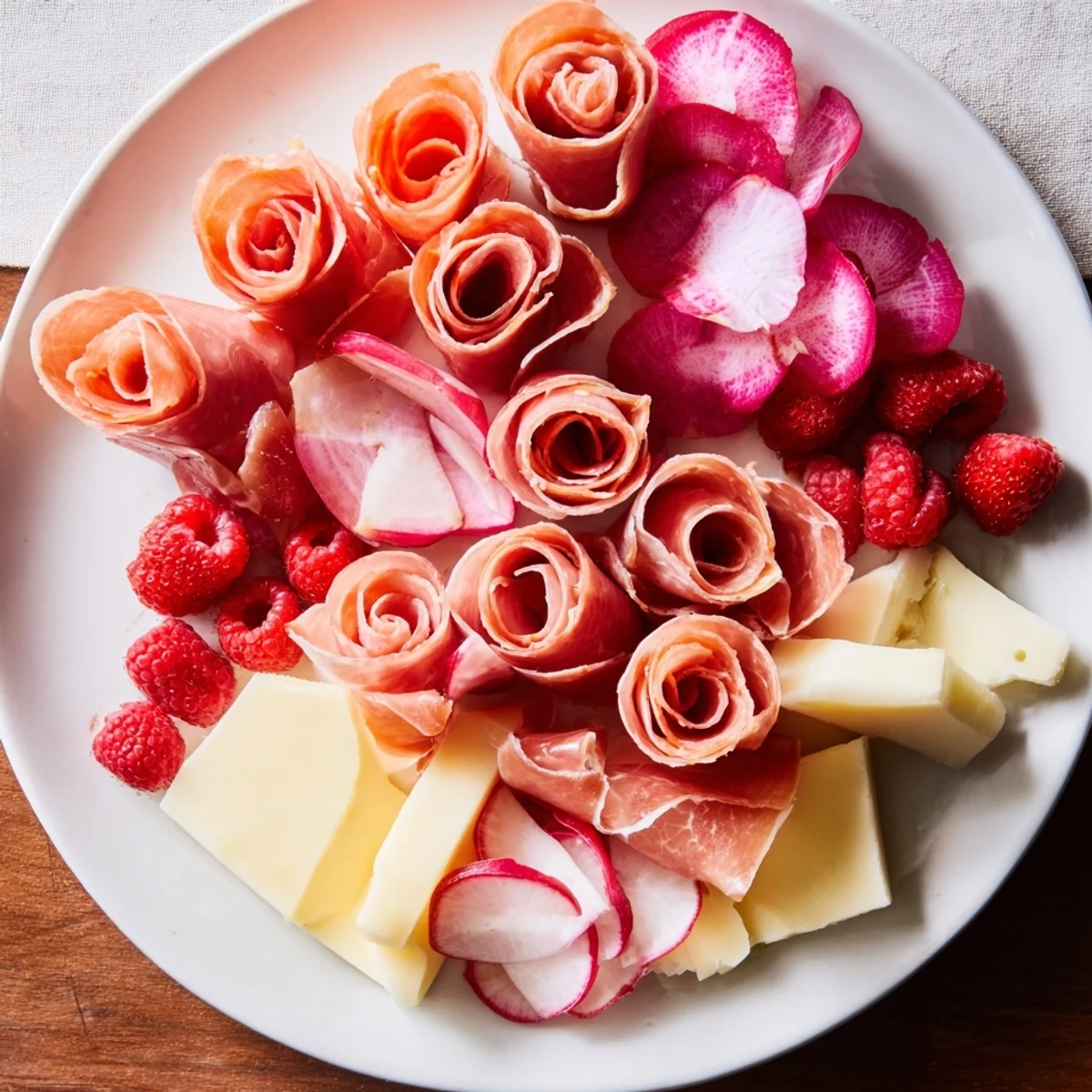 Pink Petal Watercolor Wash appetizer, a beautiful platter with pink cheese, prosciutto roses, and vibrant ingredients.