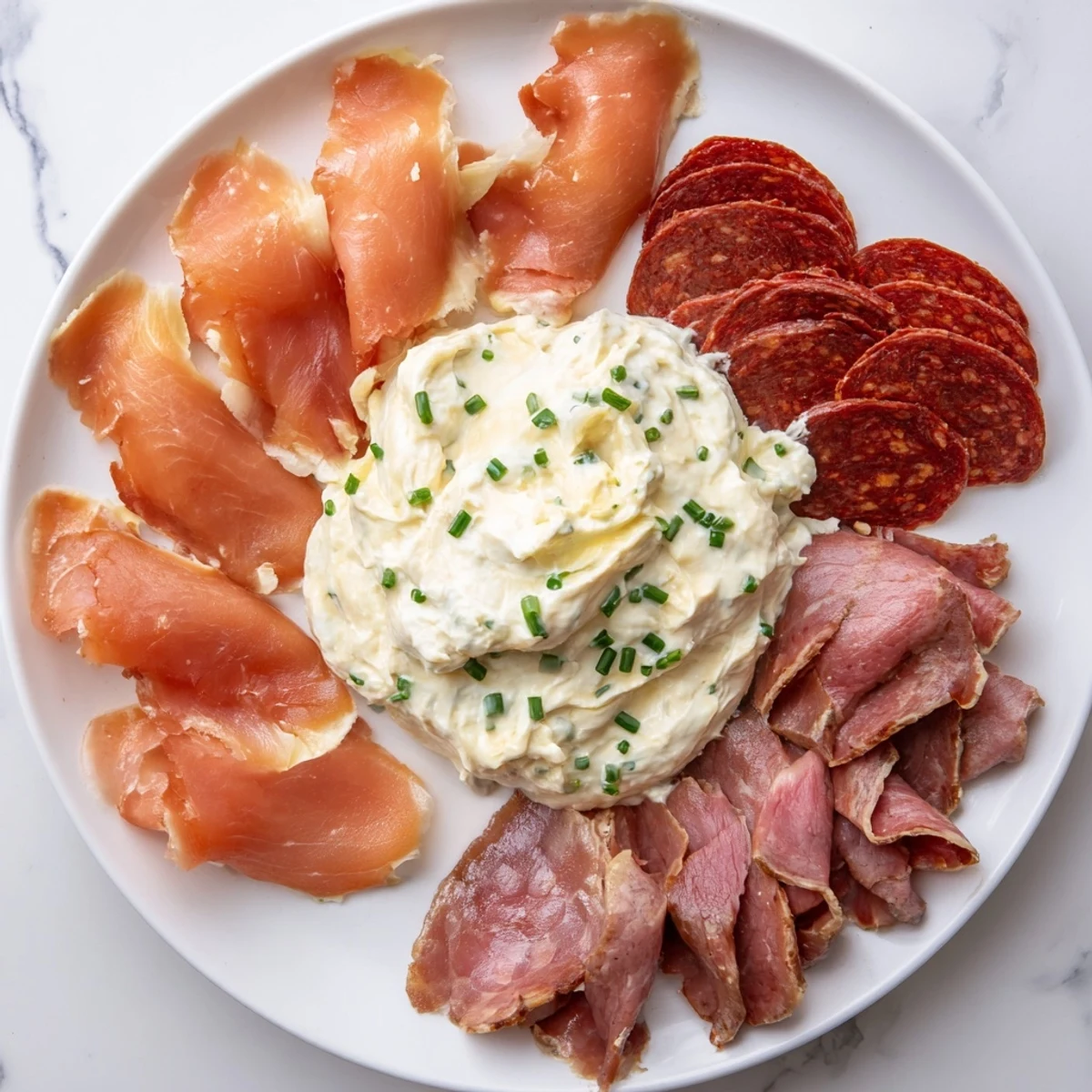 A Compass Rose platter displays smoked salmon, chorizo, prosciutto, and roast beef, ready to be enjoyed.
