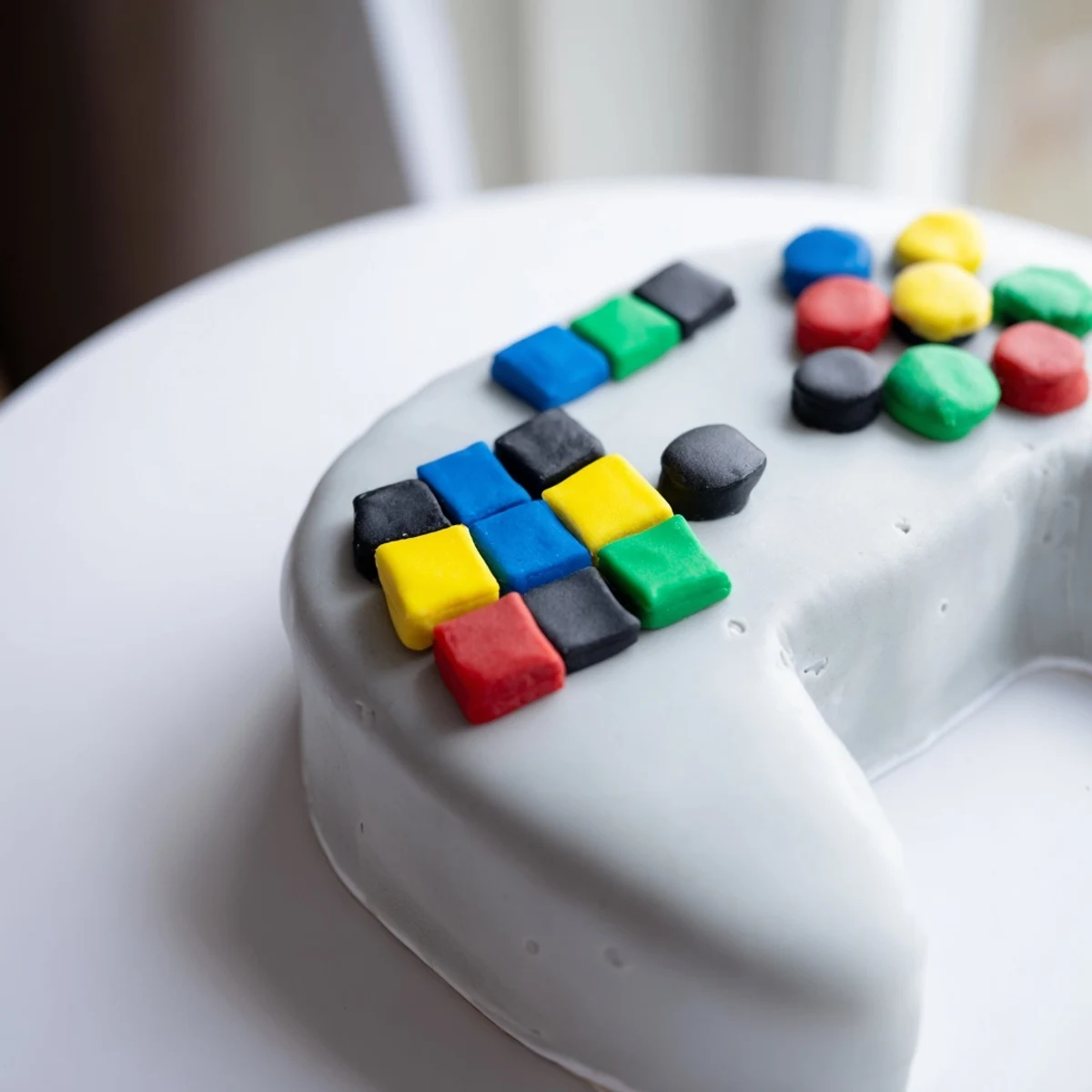 Delicious Pixel Video Game Controller Cake, featuring vibrant fondant buttons and a creamy vanilla flavor.