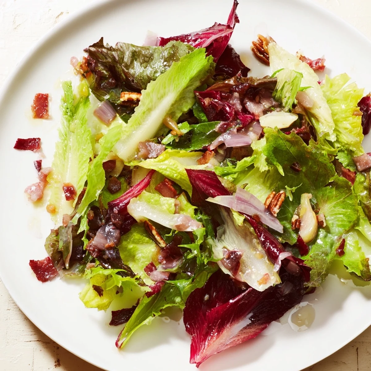 Close-up of a Bitter Greens Salad with Warm Bacon Dressing, highlighted by crispy bacon and soft greens.