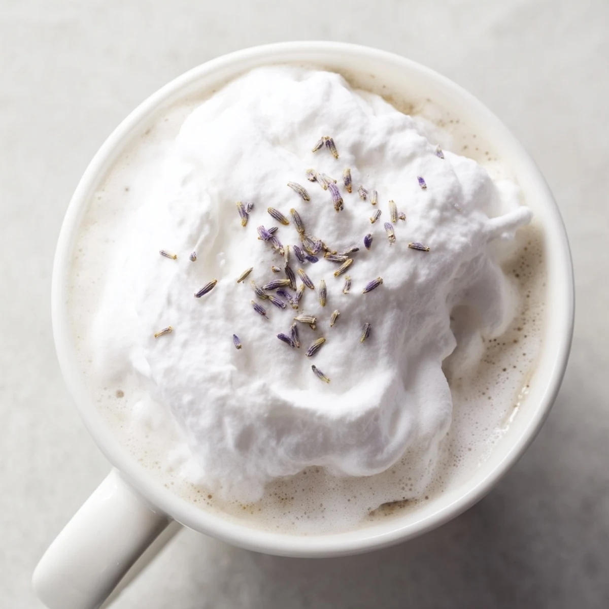 Fluffy whipped lavender foam tops a rich Whipped Lavender Latte, perfect for a cozy morning.