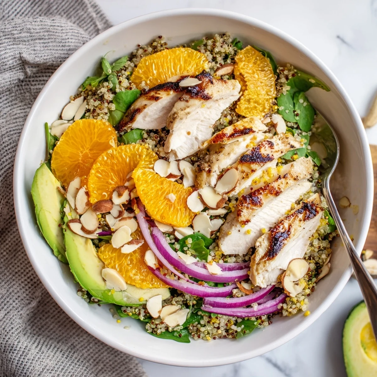 A drizzle of zesty citrus vinaigrette finishes this colorful salad bowl, garnished with toasted almonds for a satisfying crunch.
