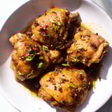Savory Filipino Chicken Adobo with glistening skin, simmering in a flavorful garlic and vinegar sauce.