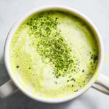 Steaming matcha green tea latte, showcasing a delicate foam layer, ready to be enjoyed.