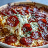 Golden brown Hot Honey Pepperoni Pizza Dip sizzling in a skillet, ready to serve.
