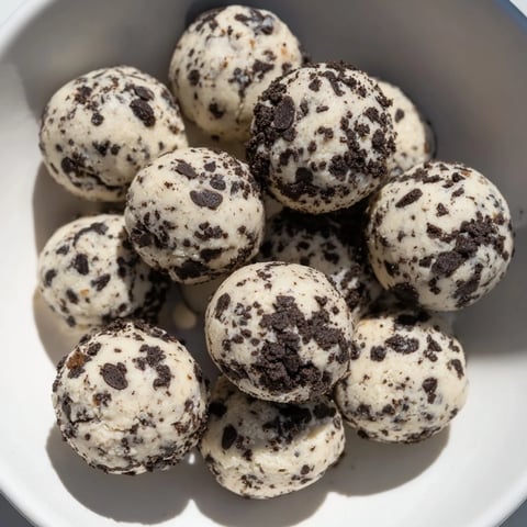 Cream Cheese Oreo Protein Balls ready to eat, showing a close-up of the creamy, crumb-covered treats.