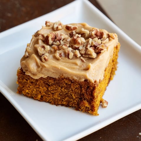 Warm pumpkin bars with rich brown sugar frosting, a decadent autumnal treat picture.