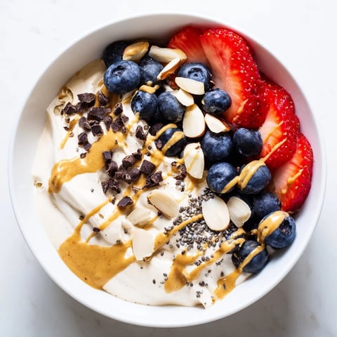 Creamy Protein Ice Cream Bowl, swirled with fresh berries, ready for a healthy dessert or snack.