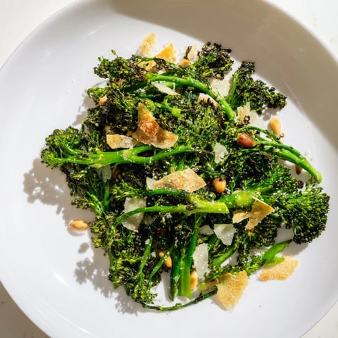 Crispy garlic chips top the vibrant Charred Broccolini Salad, a healthy vegetarian delight.