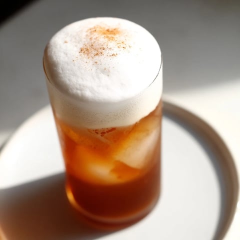 Iced Chai Tea with Cold Foam, a creamy delight, topped with pillowy cold foam and cinnamon.