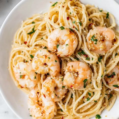 Freshly cooked spaghetti tossed with juicy lemon garlic shrimp and a silky butter sauce in a warm skillet.