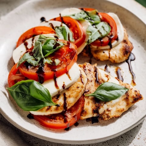 Golden-brown Caprese Chicken Skillet fresh from the stove, topped with melting mozzarella and ripe tomato slices.