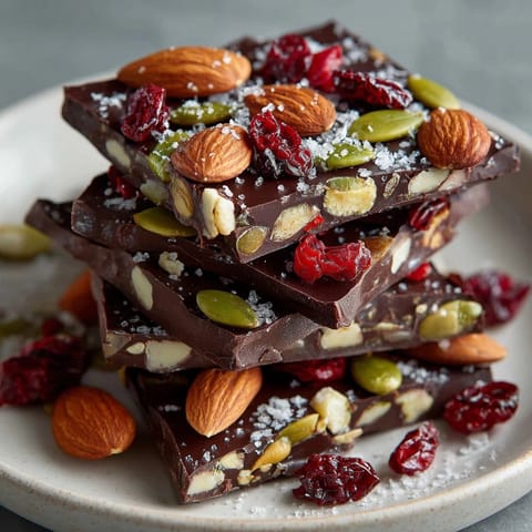 Homemade Ghost Pepper Chocolate Bark, ready to break, showing nuts, cranberries, and chocolate.