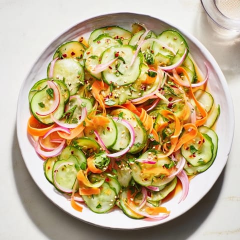 Bright and crunchy cucumber salad remix topped with sesame seeds and fresh cilantro.  