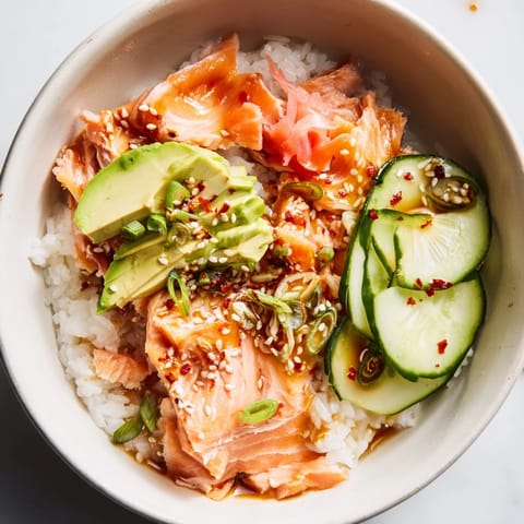 Quick and easy leftover salmon & rice bowl garnished with fresh avocado slices.  