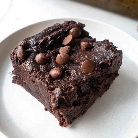 Warm, freshly baked Black Bean Brownies sitting in a pan, offering a delightful chocolate aroma.