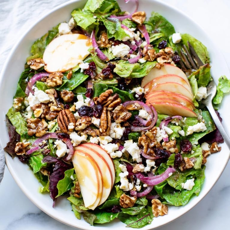 Golden toasted pecans top this Autumn Harvest Apple Feta Salad showcasing fresh ingredients.