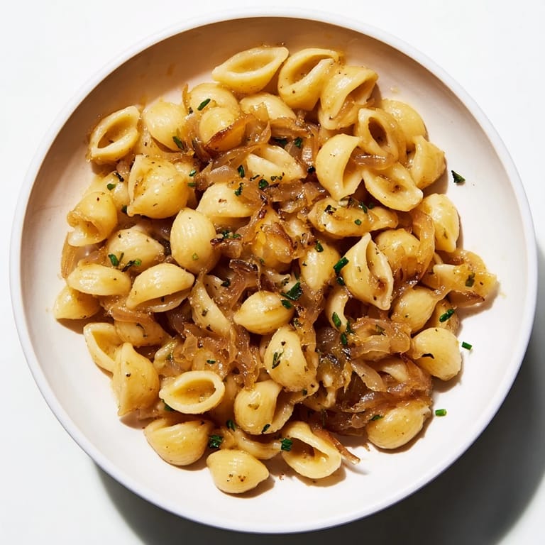 Fragrant, rich French Onion Ditalini featuring tender pasta in a savory broth with melted cheese topping.