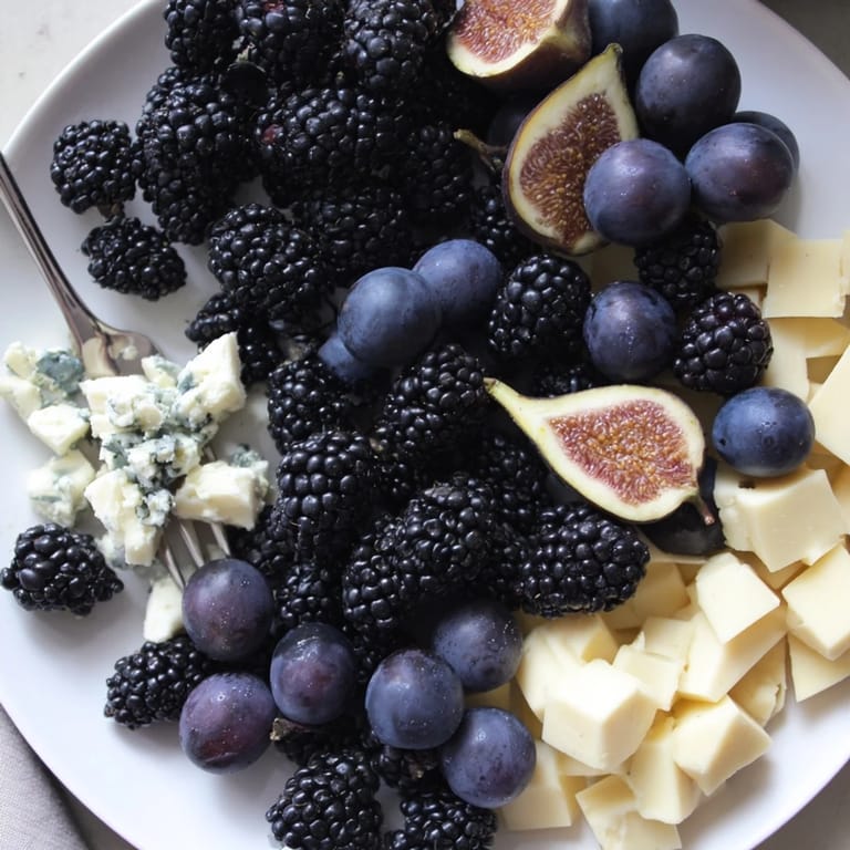 This Deep Indigo Midnight Sky cheese board features dark fruits and cheeses, evoking a truly stunning presentation.