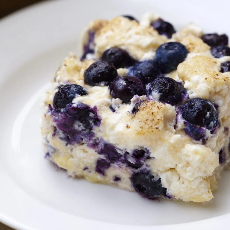 Fresh blueberries bursting in a creamy Blueberry Cottage Cheese Bake, perfect for a high-protein meal.