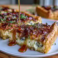 Caramelized Onion and Gruyere Tart with golden onions and melted cheese in a buttery pastry crust.