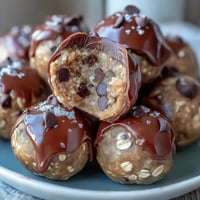 Homemade peanut butter energy balls packed with oats and dark chocolate chips for a healthy snack.  