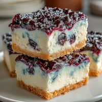 No-Bake Lemon Blueberry Cheesecake Bars: creamy, vibrant swirls with a buttery graham cracker crust.