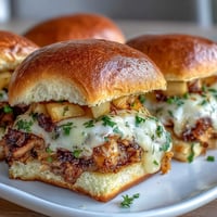 Golden Apple Cheddar Turkey Melt Sliders with melted cheese and crisp apples.